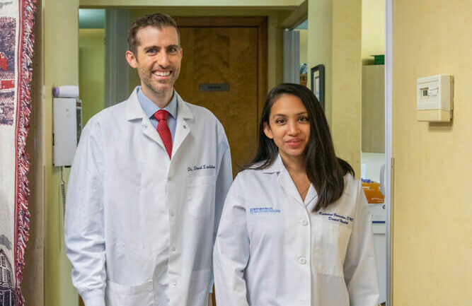 Dr. Katrina Verendia and dr. david lepelletier of Lafayette Dental in Lafayette, NJ standing in hallway of dental office